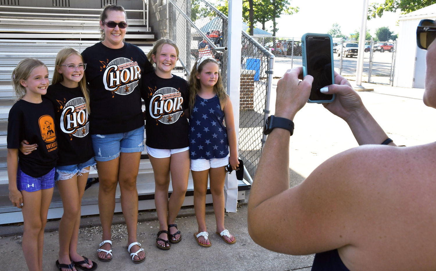 Erin Sassmann gathers for a group photo with (from left) Emilee Huebler, Kensley Harness, Brooke Tainter and Raegan Tainter after the annual Fireman’s Picnic on what was her last official event as Owensville Elementary’s choir director.
